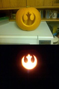 a pumpkin carved to look like a star wars symbol on top of a microwave oven