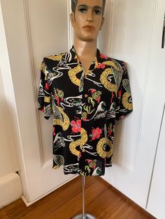 Black rayon Aloha Hawaiian shirt from Keoni of Hawaii with a beautiful print of surf boards, flowers and garlands in white, yellow, pink and green. 1940s style loop collar,wooden buttons and one chest pocket.  Excellent condition. Measurements  Shoulders 20 inches  Pit to pit 23 inches  Length 28 inches  All items sold as seen. Please contact seller for further details and offers Retro Floral Print Shirt With Camp Collar, Patterned Hawaiian Shirt With Camp Collar, Patterned Camp Collar Hawaiian Shirt, Vintage Patterned Printed Hawaiian Shirt, Hawaiian Shirt With Vintage Print And Camp Collar, Hawaiian Camp Shirt With Vintage Print, Vintage Printed Hawaiian Shirt For Beach, Vintage Printed Hawaiian Shirt For The Beach, Vintage Patterned Hawaiian Shirt For Summer