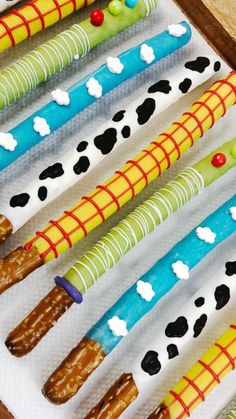 several different colored toothbrushes are lined up on a white tray with black spots