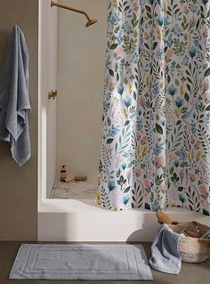 a bath room with a shower curtain and a rug