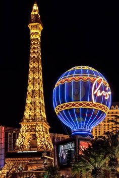 the eiffel tower is lit up at night in las vegas, nv