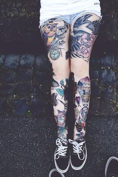 a person with tattoos on their legs and leggings