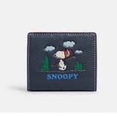 This beautiful wallet was bought from Coach and is brand new. It is kept in a clean, smoke-free and pet-free facility. Authenticity is guaranteed or your money back. Details This Coach limited edition wallet is the perfect accessory for any Snoopy or Peanuts fan. Made of blue leather with a Snoopy ski motif, this bi-fold wallet features a zipper and logo accents. The wallet is 4.25 inches long and 3.5 inches wide, making it the ideal size for a pocket or purse. The wallet has a solid pattern and is not vintage or handmade. It features a folding design and is personalized. It is perfect for women and is categorized under wallets, women's accessories, women, and clothing, shoes, and accessories. Stay organized and stylish with this Coach wallet. Orders are usually shipped the same business d Snoopy Wallet, Snap Wallet, Coach Wallet, Leather Denim, Fold Wallet, Stay Organized, Shoes And Accessories, Staying Organized, Solid Pattern