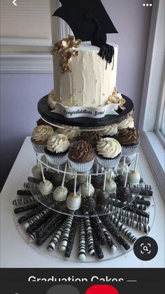 a graduation cake and cupcakes on a table