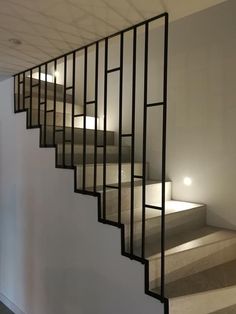 a set of stairs leading up to the second floor in a building with white walls