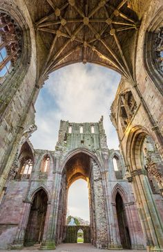 the inside of an old building with stone arches and arched doorways on both sides