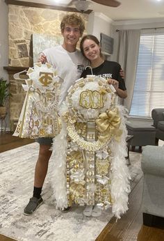 a man and woman standing next to each other in front of a table with decorations on it