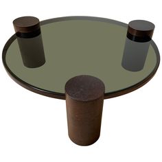 a round glass table with two wooden bases