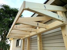 a wooden structure sitting on the side of a house