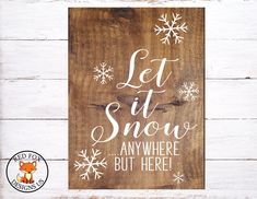 a wooden sign that says let it snow anywhere but here with white snowflakes