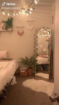 a room with a bed, mirror and plants on the wall next to each other