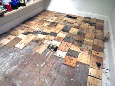 the floor is made out of wooden planks and has been stripped off with paint