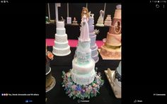 there are many wedding cakes on display at this event, including one with a bride and groom figurines