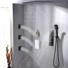 the shower head is connected to the wall and has water running from it's faucet