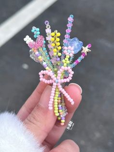 a hand holding a bunch of colorful beads