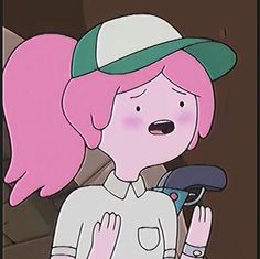 a girl with pink hair wearing a green hat