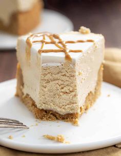 a piece of cheesecake with caramel drizzle on top is sitting on a white plate