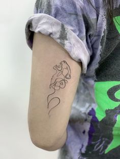 a woman's arm with a tattoo on it that has an image of a cat