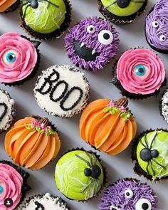 cupcakes decorated to look like monsters and pumpkins with the word boo on them