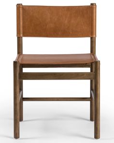 a brown leather chair sitting on top of a white floor next to a wooden frame