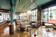 an empty restaurant with lots of tables and chairs