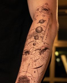 a man's arm with tattoos on it that have different types of planets and hands