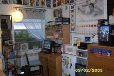 a room filled with lots of clutter and pictures hanging on the wall next to a window