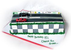 a birthday cake that is shaped like a race track