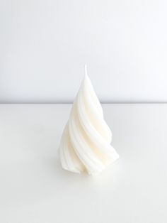 a white candle sitting on top of a table