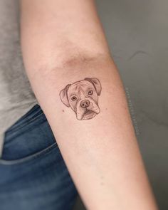 a dog's face is drawn on the arm and it looks like he has his head