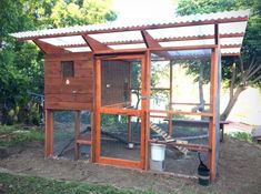 an outdoor chicken coop in the middle of a yard