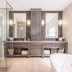 a large bathroom with two sinks and a bathtub