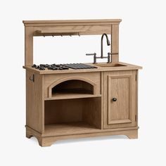 a wooden stove top oven sitting under a faucet