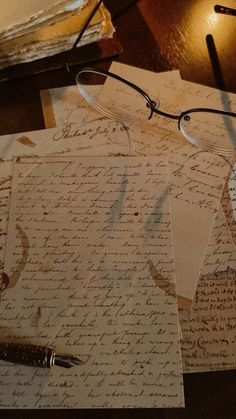 several old letters and glasses on a table