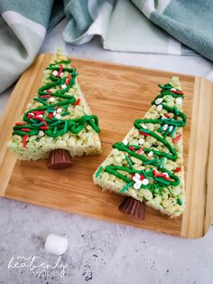 two slices of christmas tree rice krispy treats on a cutting board