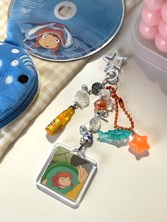 there is a keychain that has been placed next to other items on the table