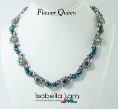 a necklace with blue and silver beads on a white mannequin