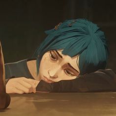 a woman with blue hair leaning on a table