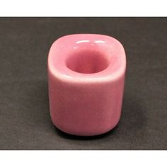 a pink vase sitting on top of a table