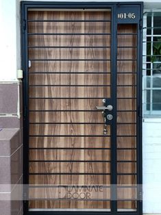 a wooden door with metal bars on the front and side doors that are closed to let in light