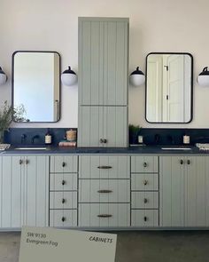 a bathroom with two sinks and three mirrors