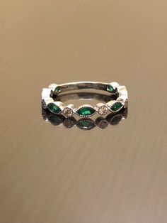 DeKara Designs Collection Metal- 18K White Gold, .750. Stones- 7 Genuine Marquise Colombian Emeralds 0.45 Carats, 6 Round Diamonds F-G Color VS2 Clarity 0.15 Carats. Size- 4-12 Beautifully Handmade 18K White Gold Diamond Colombian Emerald Engagement Band. All the emeralds are a high quality, with a beautiful rich green and marquise in shape. You get the most brilliance from these emeralds do to a superior color and because of it's origin. The emeralds are a beautiful green and are matched by col Emerald Wedding Jewelry With Pave Setting, Emerald Eternity Band, Art Deco Emerald, Sapphire Band, Engagement Band, Colombian Emeralds, Emerald Engagement, Rich Green, Engagement Bands