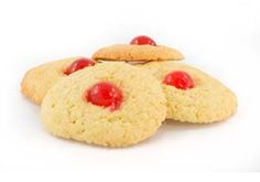 three cookies with cherries on the top