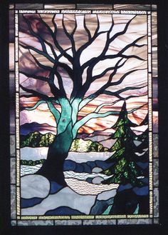 a stained glass window with a tree in it