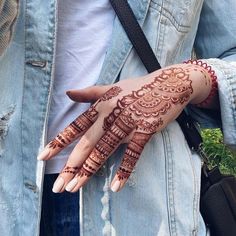 a woman's hand with henna on it