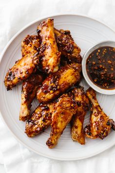 chicken wings on a plate with dipping sauce