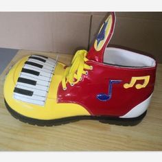 a pair of yellow and red shoes with musical notes painted on them