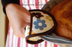 a person is holding a cake in a pan with flowers on it and an easter egg