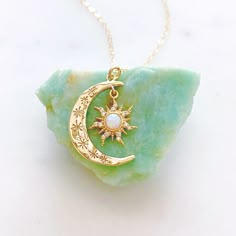 "DESCRIPTION: The AURORA Necklace - Gold crescent moon + opal sun pendant on a dainty gold filled chain. Wear it on its own for a celestial statement or layer it up with your favorite necklaces, either way your going to want to wear this beauty again and again. We love this celestial necklace and think you will too! MATERIALS: Chain, clasp, and jump rings - Gold filled Pendant - Gold plated, Opal, CZ stones PENDANT SIZE: Approximately 1\" in length PACKAGING: Your necklace will arrive on a Daint Celestial Necklaces With Sun And Moon Design For Gift, Celestial Sun And Moon Design Necklace As Gift, Mystical Sun And Moon Necklace For Gift, Celestial Jewelry For May Birthstone Gift, Magical Sun And Moon Design Necklace Gift, Magical Sun And Moon Design Jewelry As Gift, Crescent Necklace As A Gift, Magical Crescent Necklace For Gift, Celestial Opal Round Necklace