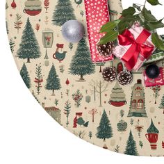 christmas wrapping and presents on a table with holly leaves, pine cones, berries, firs